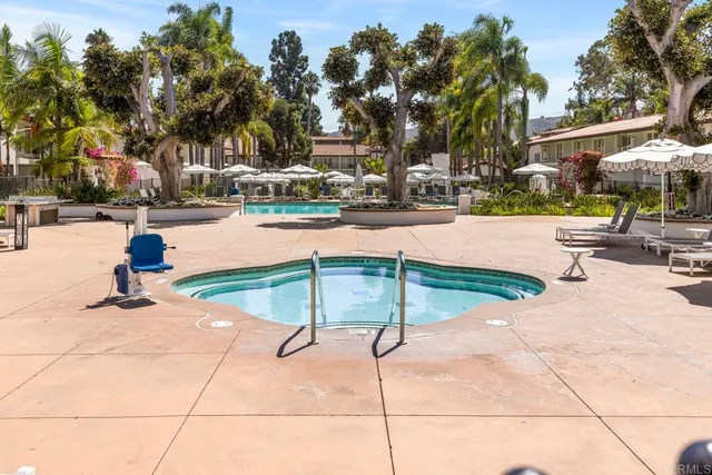 an aerial view of a swimming pool and outdoor seating