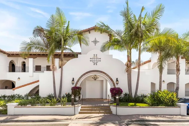 a front view of multiple houses with yard