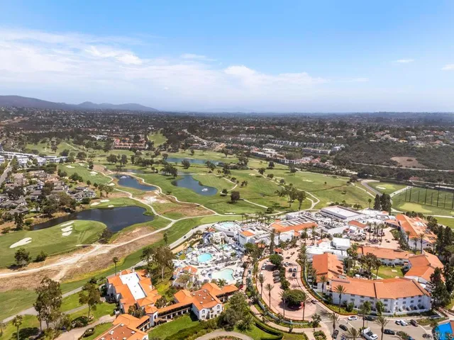an aerial view of residential building with green space
