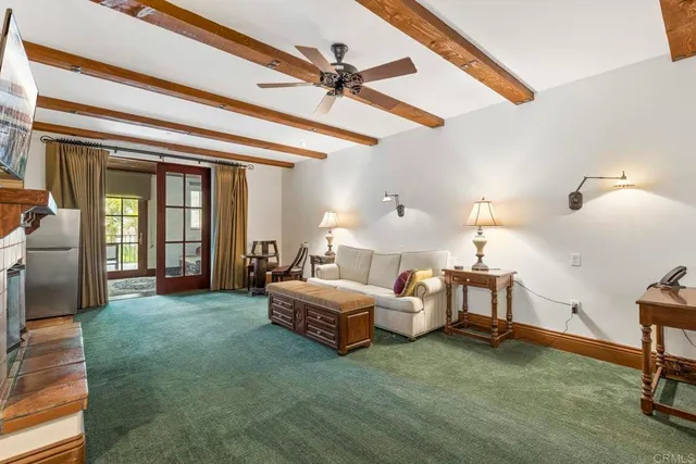 a living room with furniture and a ceiling fan