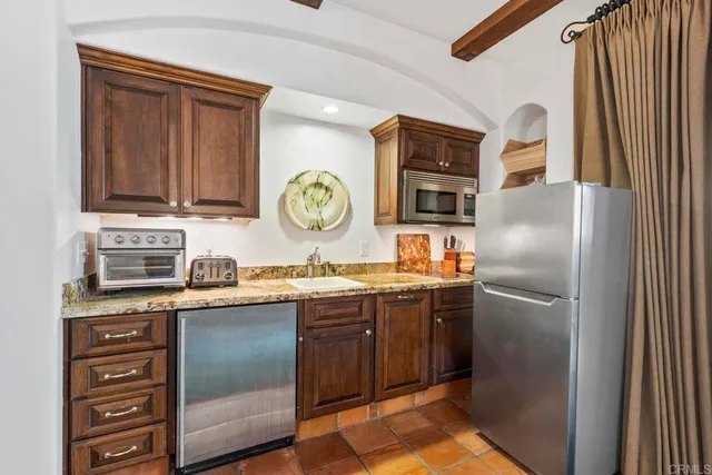 a kitchen with granite countertop a stove and cabinets