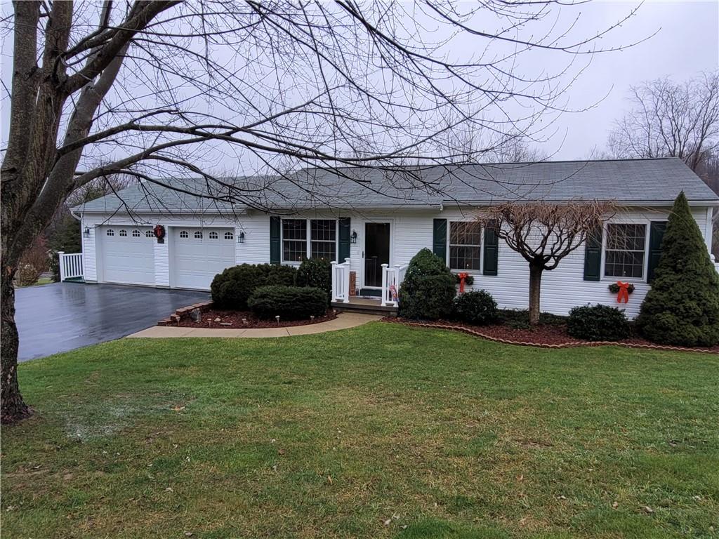 a front view of house with yard and outdoor seating
