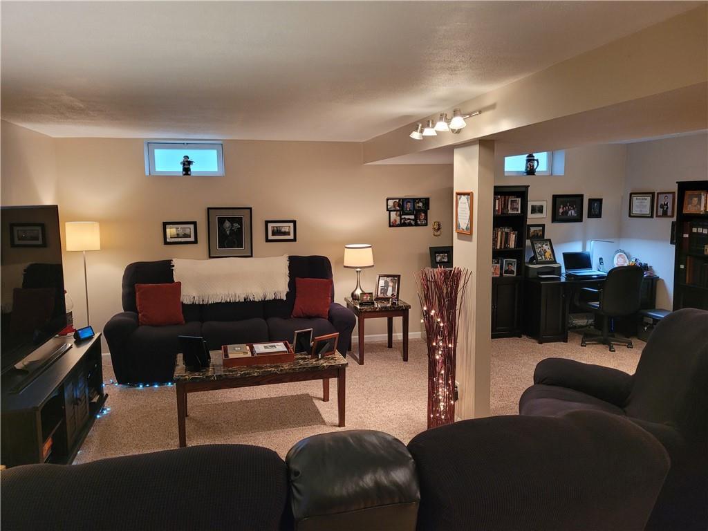 662 Great Belt Road Butler, PA 16002 - Photo 23 of 25 a living room with furniture a flat screen tv and kitchen view