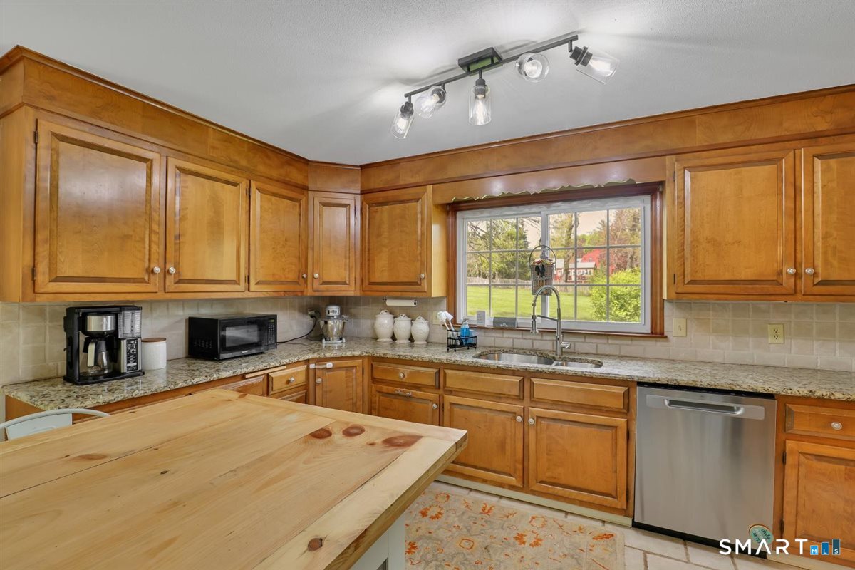 72 Old Post Road Wethersfield, CT 06109 - Photo 8 of 40 a kitchen with stainless steel appliances granite countertop a sink window and cabinets