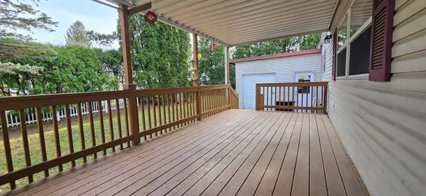 a view of a house with deck and wooden floor
