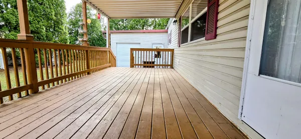 a view of deck with wooden floor and fence