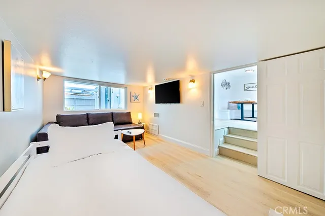 a spacious bedroom with a bed and a chandelier