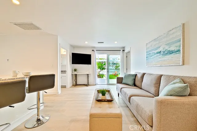 a living room with furniture flat screen tv and white floor