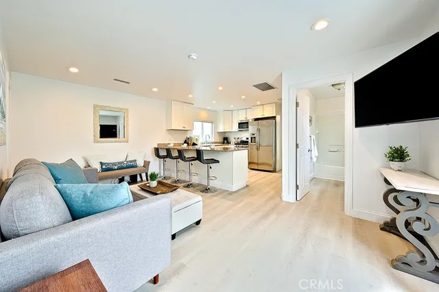 a living room with furniture and kitchen view