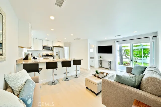 a large white kitchen with cabinets and a window