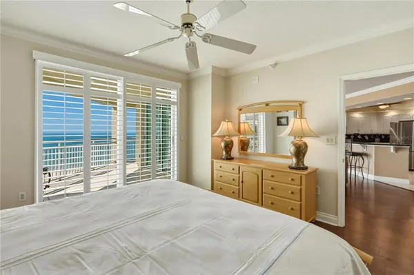 a spacious bedroom with a large bed and a chandelier