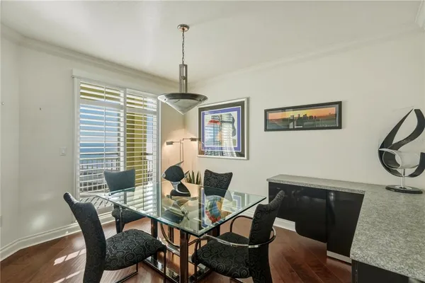 a view of a dining room with furniture window and wooden floor