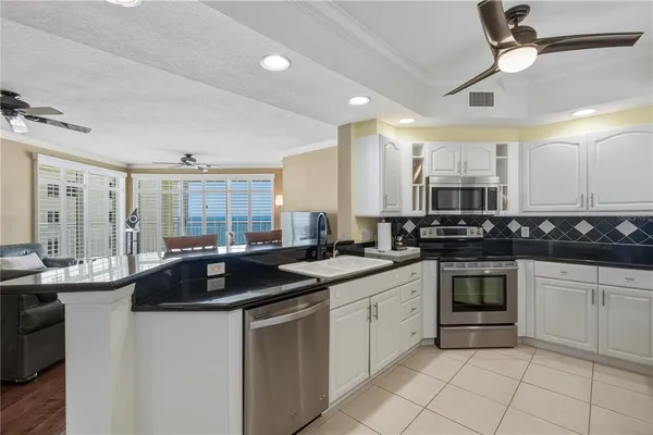 a kitchen with a sink cabinets and stainless steel appliances