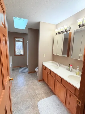 a bathroom with a double vanity sink and mirror