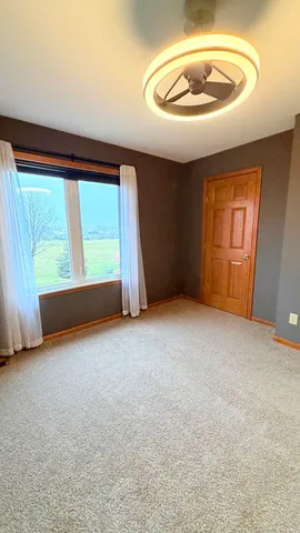 a view of a room with a table and chairs