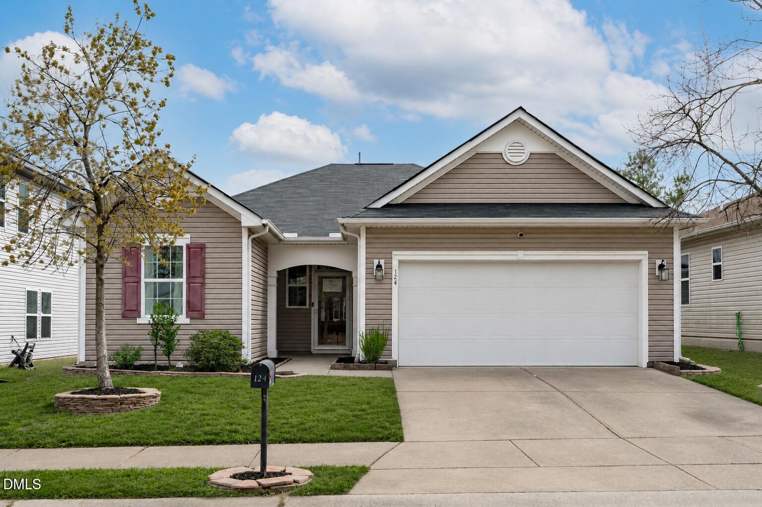 124 Daneborg Road Durham, NC 27703 - Photo 1 of 40 a front view of a house with a garden and yard