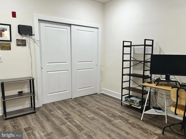 a view of a workspace with furniture and wooden floor