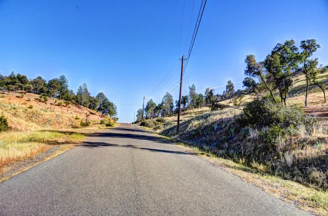 an aerial view of mountain with trees around