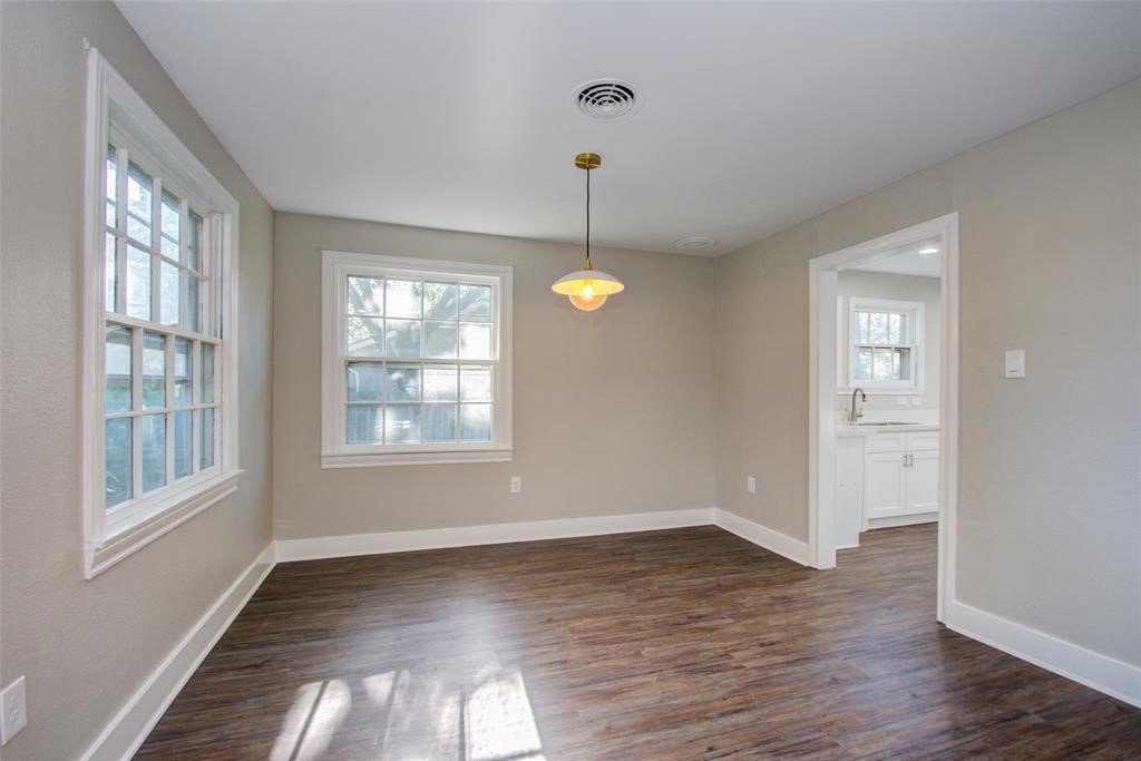 417 Sue Street, Unit A Houston, TX 77009 - Photo 4 of 11 a view of an empty room with wooden floor and windows