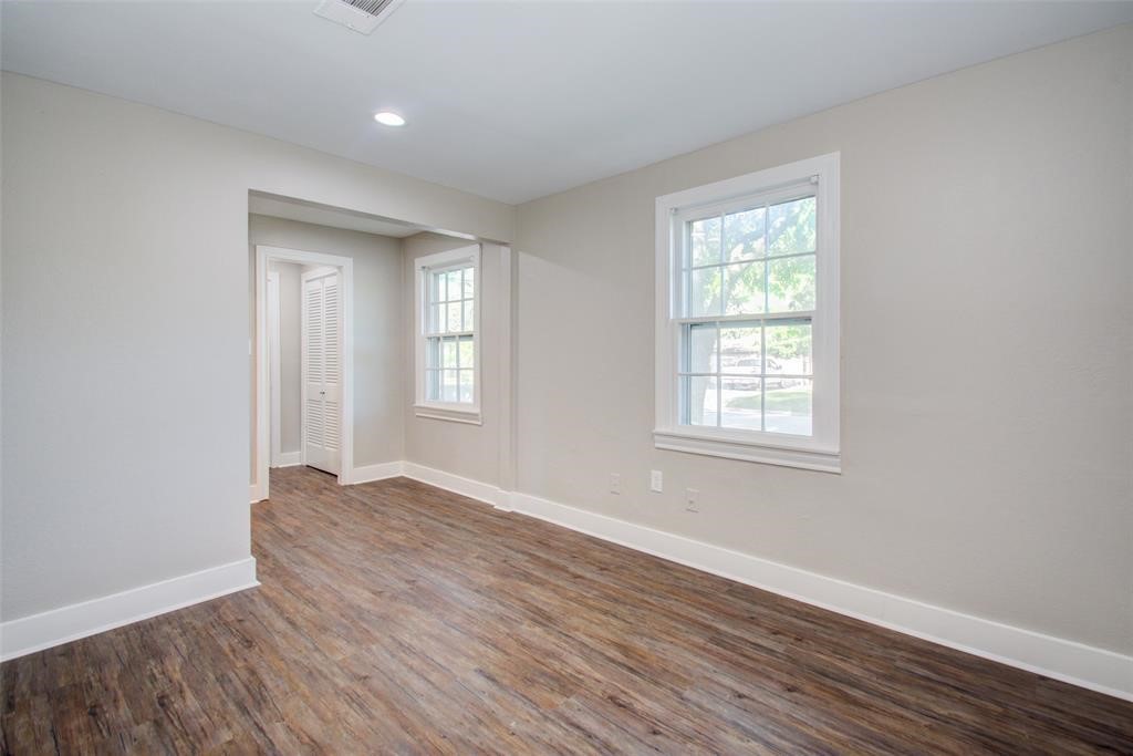 417 Sue Street, Unit A Houston, TX 77009 - Photo 6 of 11 an empty room with wooden floor and windows