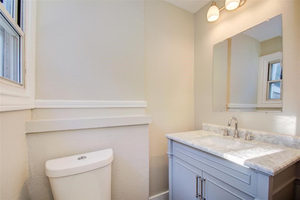 417 Sue Street, Unit A Houston, TX 77009 - Photo 9 of 11 a bathroom with a granite countertop sink and a toilet
