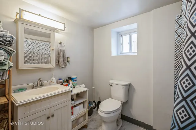 a bathroom with a sink toilet and mirror
