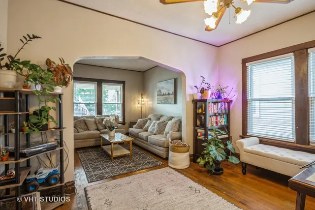 a living room with furniture and a potted plant
