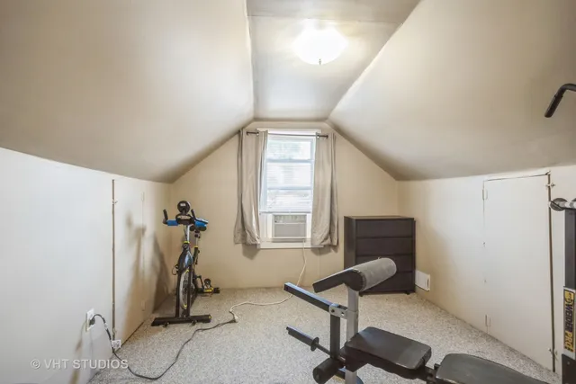 a view of a room with gym equipment and a window