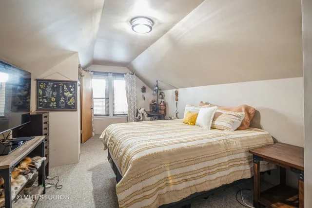 a bedroom with a bed and a desk