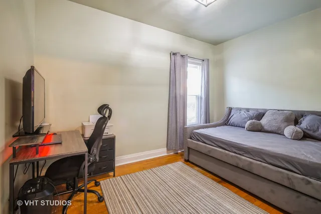 a living room with furniture a flat screen tv and a rug
