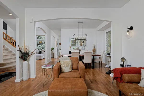 a living room with furniture and a chandelier