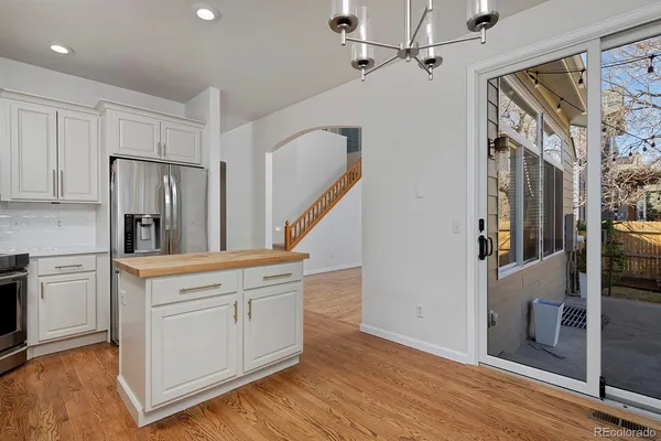 a kitchen with stainless steel appliances granite countertop a refrigerator and a stove top oven