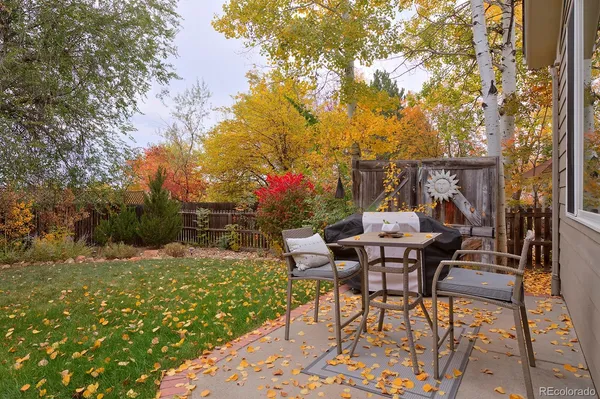 a view of a chairs and table in backyard