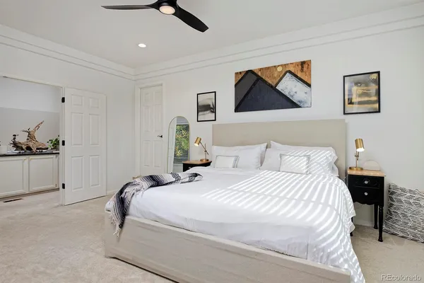 a bedroom with bed and wall painting