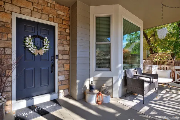 a view of a porch with chairs and backyard