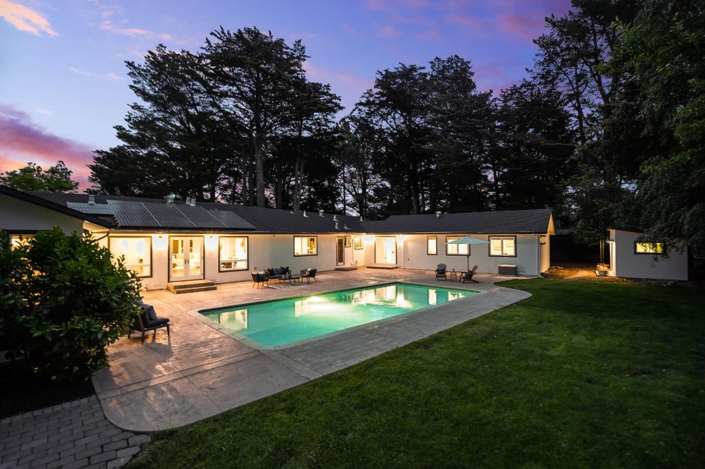 a view of a swimming pool with an outdoor space and seating area