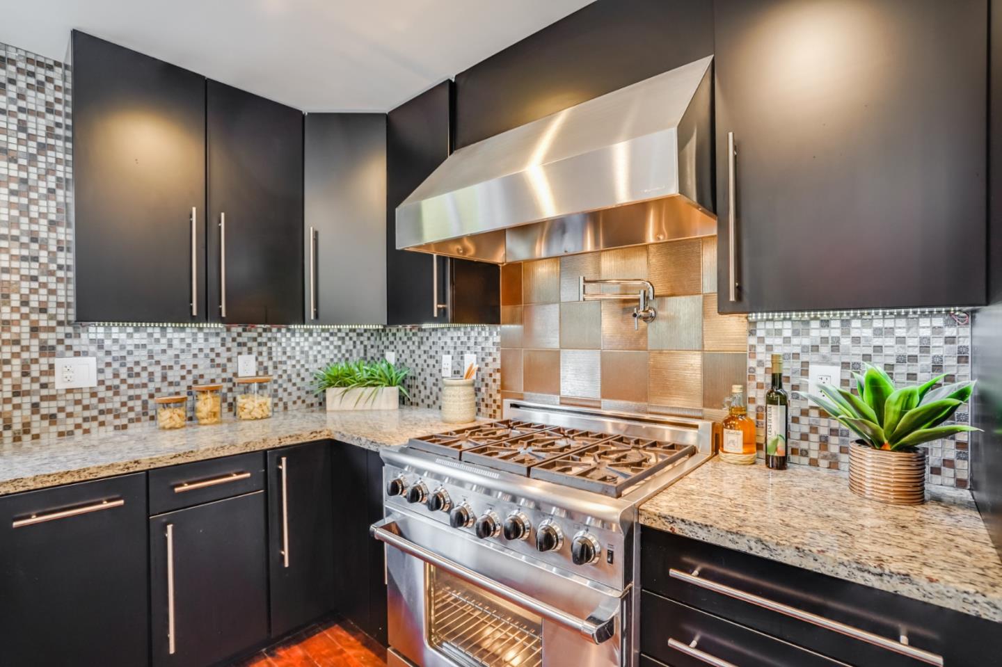 309 Darrell Road Burlingame, CA 94010 - Photo 29 of 94 a kitchen with stainless steel appliances granite countertop a sink a stove and a wooden floor