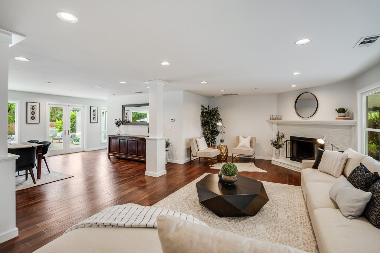 309 Darrell Road Burlingame, CA 94010 - Photo 43 of 94 a living room with furniture a fireplace and potted plants with wooden floor