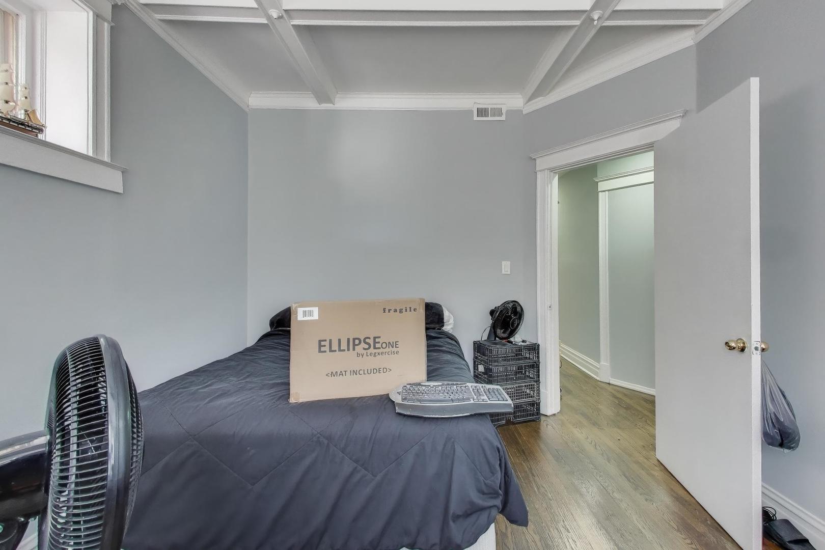 6149 South Rhodes Avenue Chicago, IL 60637 - Photo 11 of 50 a view of a hallway with wooden floor and furniture