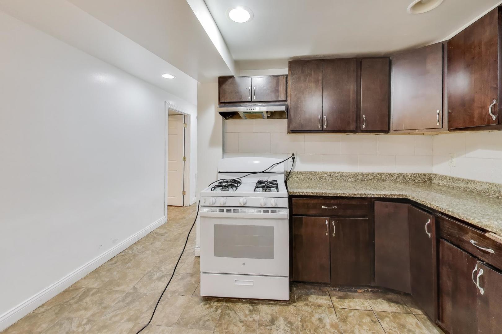 6149 South Rhodes Avenue Chicago, IL 60637 - Photo 35 of 50 a kitchen with a stove and a sink