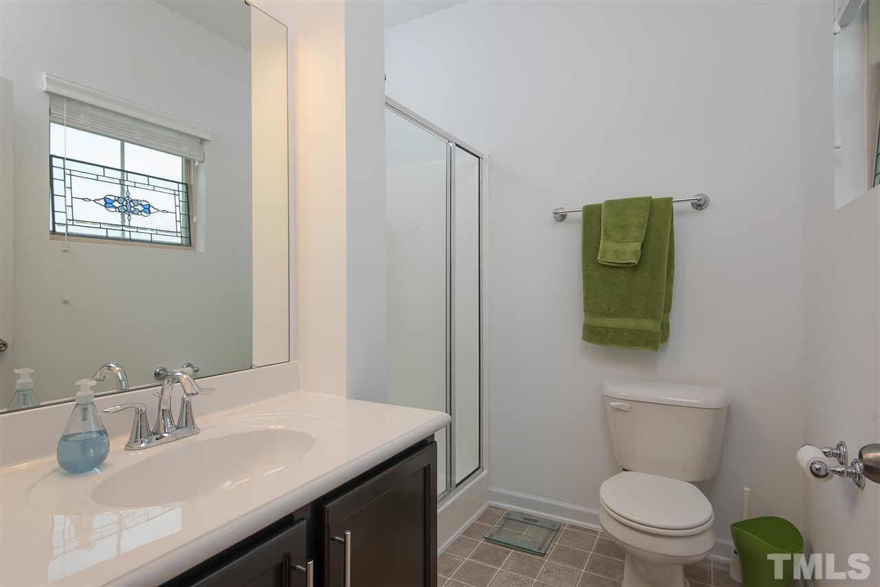 1607 Crafton Way Raleigh, NC 27607 - Photo 14 of 17 a bathroom with a toilet a sink and mirror