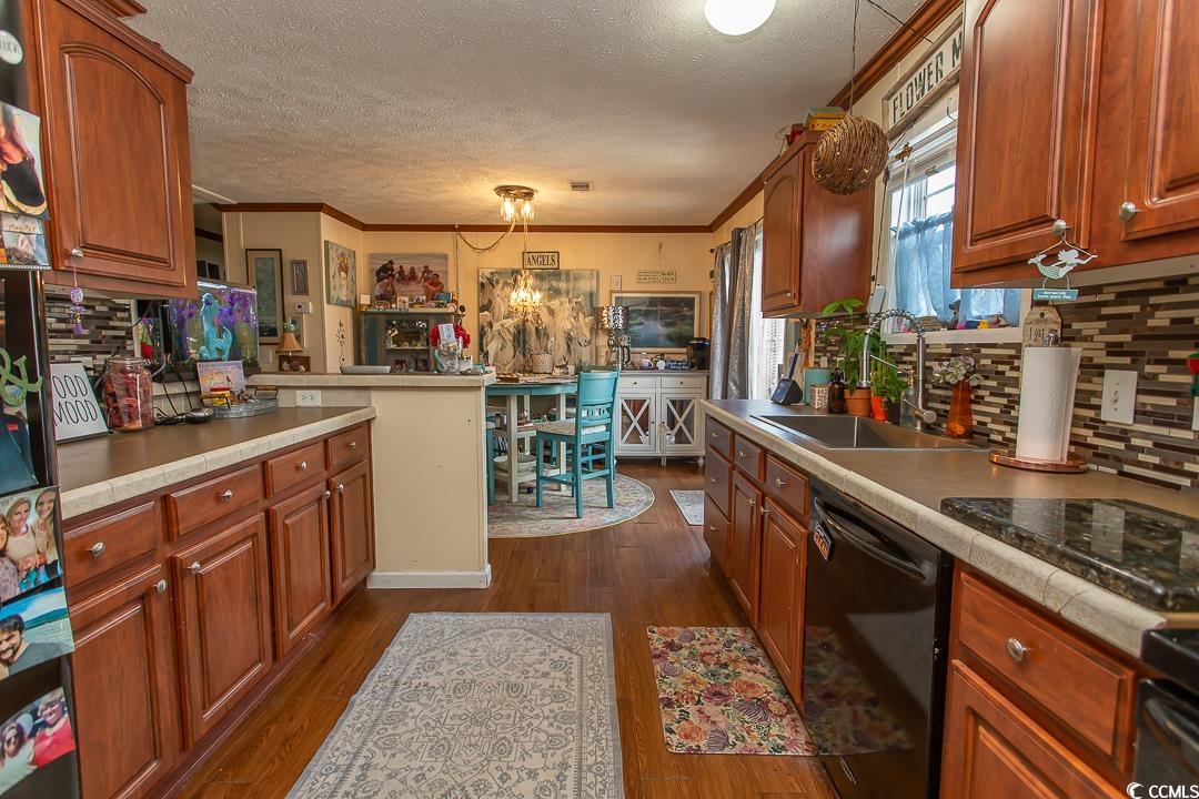 1051 Hunter Way Conway, SC 29526 - Photo 11 of 27 Kitchen with sink, crown molding, dark wood-type f