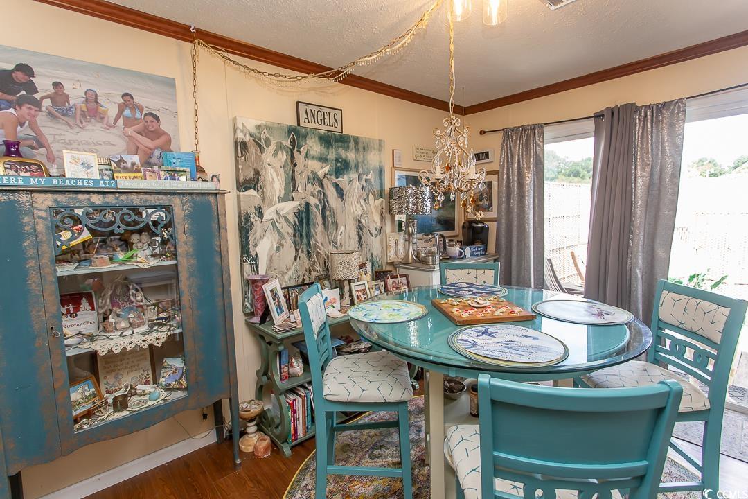 1051 Hunter Way Conway, SC 29526 - Photo 14 of 27 Dining area featuring crown molding, hardwood / wo