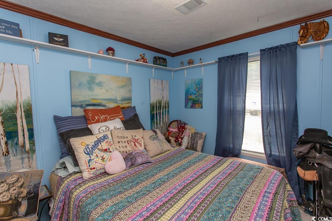 1051 Hunter Way Conway, SC 29526 - Photo 19 of 27 Bedroom featuring a textured ceiling