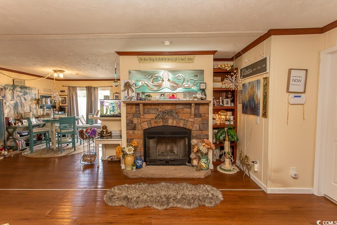 1051 Hunter Way Conway, SC 29526 - Photo 9 of 27 Living room with crown molding, a stone fireplace,