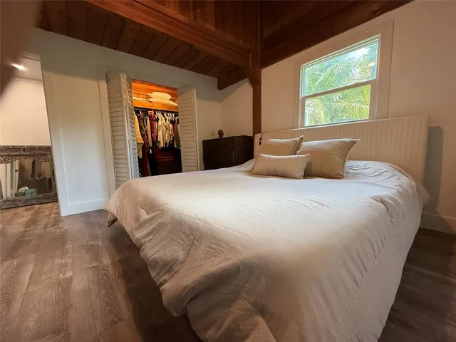 a bedroom with a bed and a large window