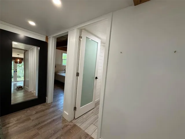 a view of a hallway with wooden floor