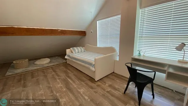a spacious bathroom with a window and a table