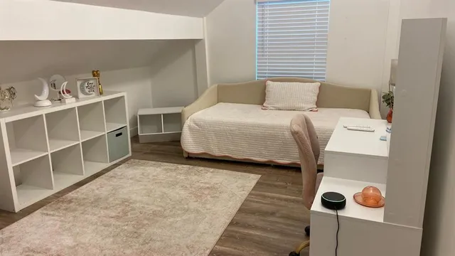 a bedroom with a bed and a window