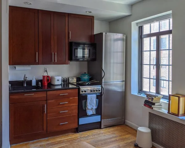 a kitchen with stainless steel appliances granite countertop a refrigerator stove and sink